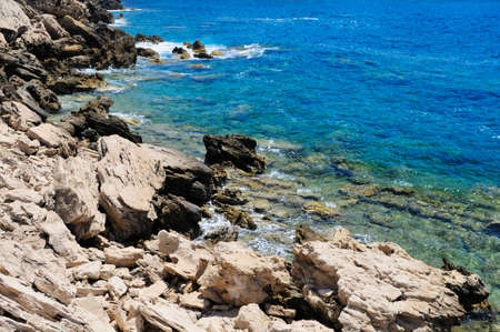 Rocky shore of the Mediterranean sea with clear water.の写真素材