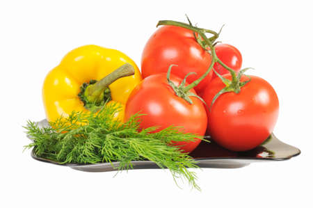 Vegetables - Tomatoes, peppers on a plate with dill. Isolated on white.の写真素材