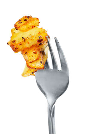Fried potatoes  on  a fork   Isolated  on white の写真素材