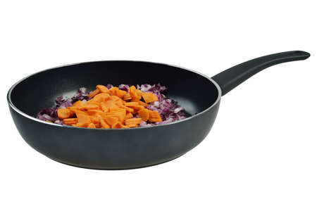 Onions and carrots in a frying pan  Isolated on white の写真素材