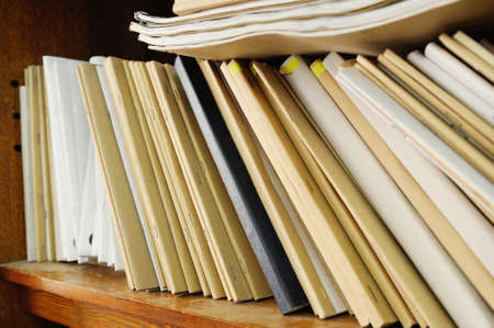 Wooden shelf with file folders, archival documents 