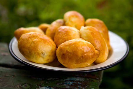 Hot fresh pies on an iron plate close up