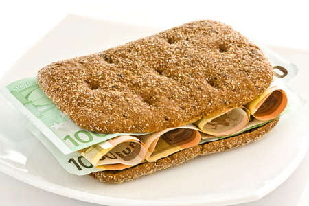 Fresh bread with a layer of monetary denominations insideの写真素材