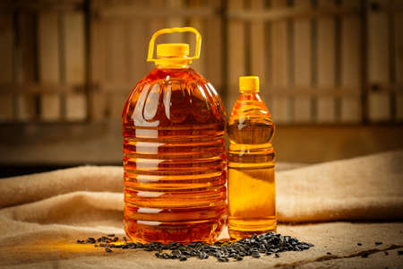 Sunflower oil in plastic bottles isolated on sackclothの写真素材