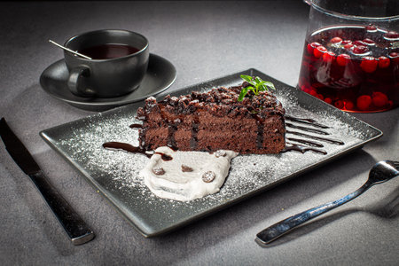 A piece of chocolate cake with mint on the tableの写真素材