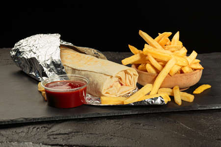 Shawarma sandwich gyro fresh roll of lavash chicken beef. Traditional Middle Eastern snack.の写真素材