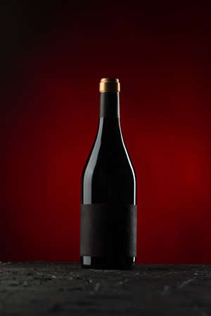 Bottle of wine on red backgroundの写真素材