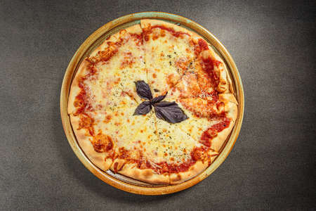 Four Cheeses Pizza topped with mozzarella, emmental, gorgonzola and goat milk cheese flavored with herbsの写真素材