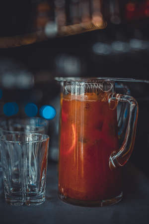 Sangria Spanish drink of red wine mixed with lemonade, fruit, and spices. Cold fresh red wine drink with ice and fruit in decanter with wineglasses in wine glassの写真素材