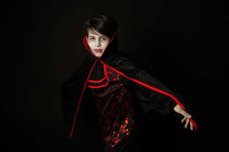 Cute boy dressed up as vampire for the halloween party.の写真素材