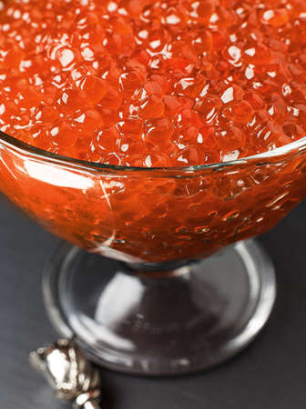 Red caviar in a glass bowl. Christmas and New Year backgroundの写真素材