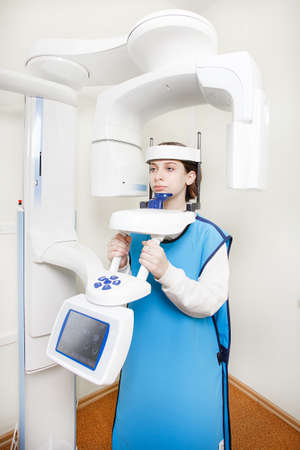 A girl makes a panoramic rengen. health care concept. vertical photo.の写真素材