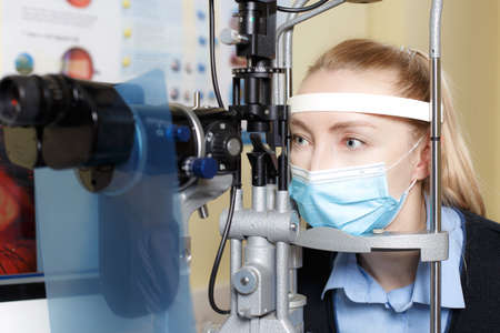 Portrait of a Caucasian female checking eyesight in an ophthalmologist clinicの写真素材