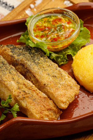 grilled fish pieces with mamaliga, closeup