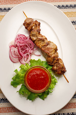 Shashlik on a wooden skewer, top view, closeupの写真素材