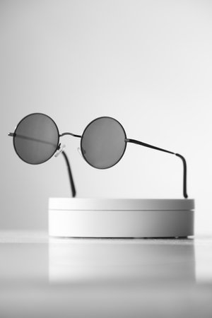 Trendy sunglasses background. Fashion summer accessories. Copy space for text. Black white concept. Optic store discount posterの写真素材