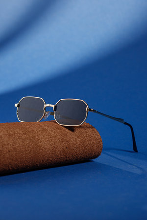 Trendy sunglasses background. Fashion summer accessories. Copy space for text. Blue concept. Optic store discount posterの写真素材