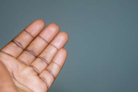 Dark African hands open showing inside of dark palm and fingersの写真素材