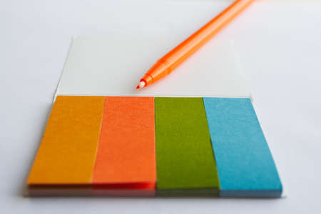 colorful notpad on a white background with a pen.の写真素材