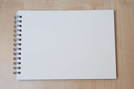 An empty drawing book on a desk.