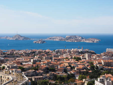 Marseille city view from high hill in a sunny day with mediterranean sea and islands in the far の写真素材