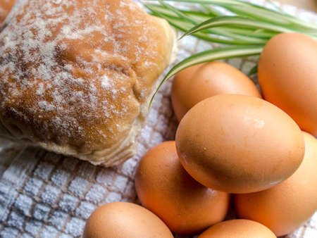 Bun and eggs in kitchen with light from windows の写真素材