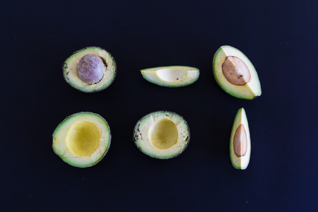 sliced avocado on black backgroundの写真素材