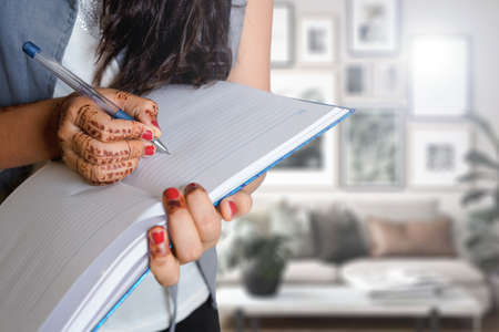 Indian little girl writing, drawing on blank space