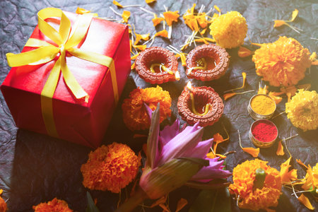 Beautiful clay Diya lamps lit during diwali celebration, Diwali gift and festival backgroundの写真素材