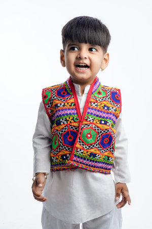 Cute indian little child in ethnic wear and showing expression over white backgroundの写真素材