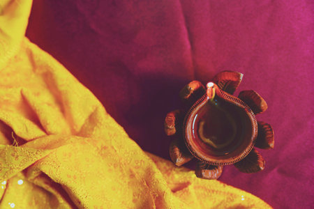 Happy Diwali - Diya lamps lit during diwali celebrationの写真素材