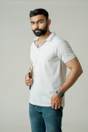 Young indian man standing with note book, isolated on whiteの写真素材