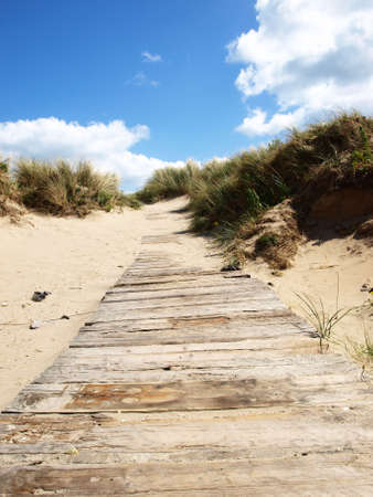 wooden and sandy pathway to beach