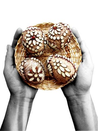 four handmade Easter eggs at plate on hands