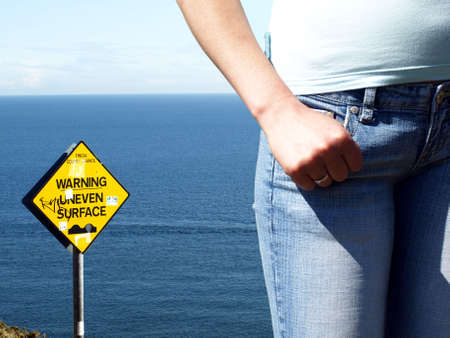 female beside the sign on the sea backgroundの写真素材