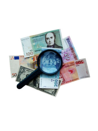 magnifier on different banknotes in the blurの写真素材