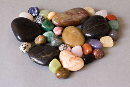 heart shape of colorful stones  on grey backgroundの写真素材