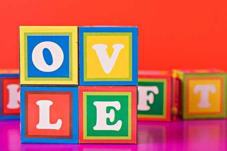 colorful word "love" spelled out in baby blocks の写真素材