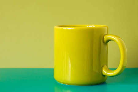  green  teacup isolated on the colorful backgroundの写真素材