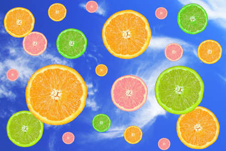 citrus fruits slices, falling in a blue skyの写真素材