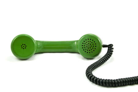 Old-fashioned green  telephone receiver with cord on white background の写真素材