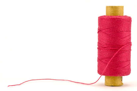 red thread spool , isolated on white background の写真素材