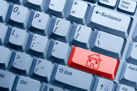  red computer  keyboard button with house iconの写真素材