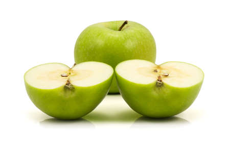 one green apple and two halfs,isolated on white backgroundの写真素材
