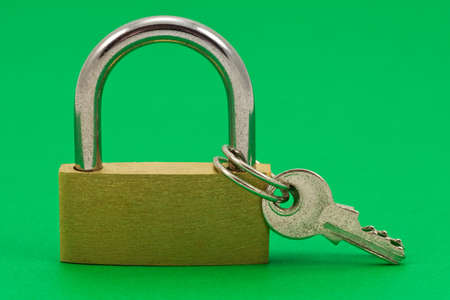  padlock with keys, isolated on green backgroundの写真素材