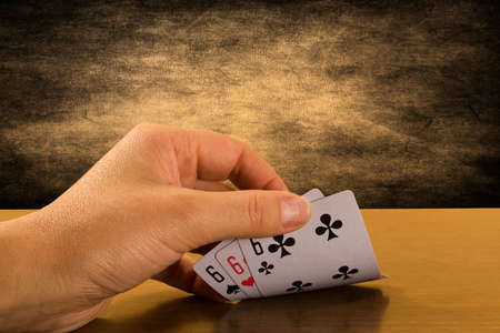 risk and success . Player hand revealing triple six