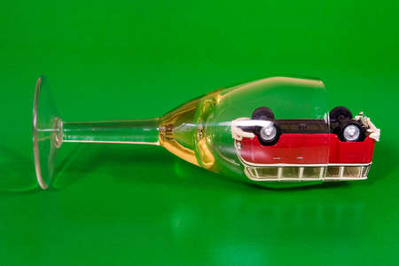 car in wine glass. isolated on greenの写真素材