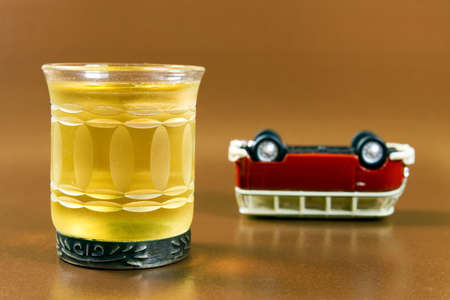  drink and upended car. isolated on brownの写真素材