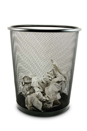 Garbage bin with paper waste isolated on white の写真素材