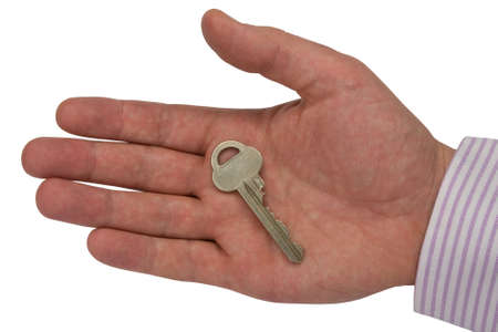 metal key in hand .isolated on white background